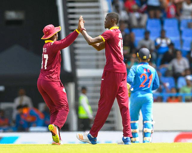 Evin Lewis and Alzarri Joseph celebrate Dinesh Karthik's dismissal