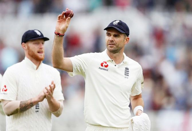England's James Anderson celebrates with the ball after cleaning up the South African tail