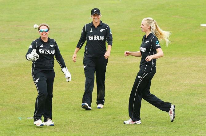 New Zealand players celebrate the fall of an Indian wicket