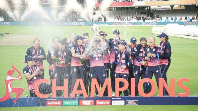 England celebrate with the ICC Women's World Cup trophy after defeating India at the Lord's in London on Sunday