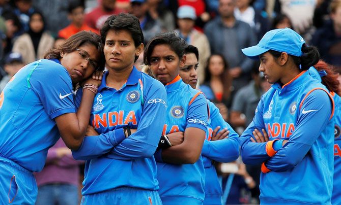 India's Jhulan Goswami (left) and teammates wear a dejected look at the end of the World Cup final on Sunday