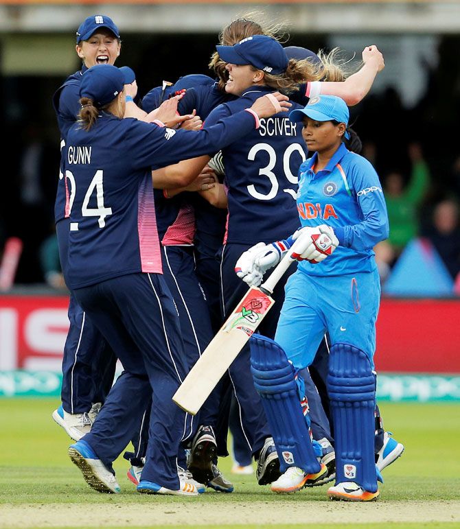 England players celebrate winning their ICC Women's World Cup match against India at Lord's on Sunday