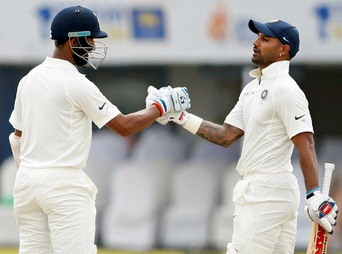 Shikhar Dhawan, right, with Cheteshwar Pujara