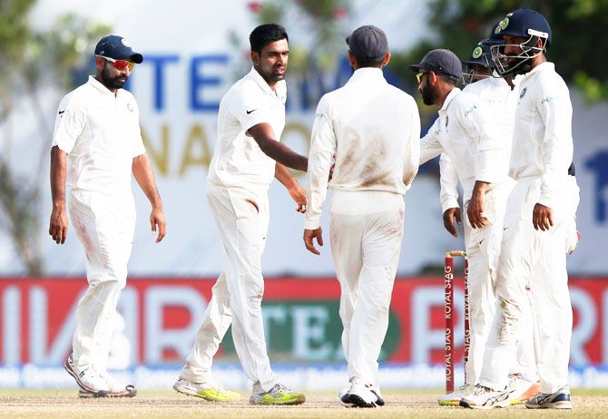 India's Ravichandran Ashwin celebrates with teammates after taking the wicket of Sri Lanka's Nuwan Pradeep