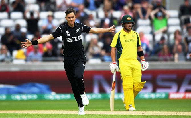 Trent Boult celebrates after dismissing David Warner