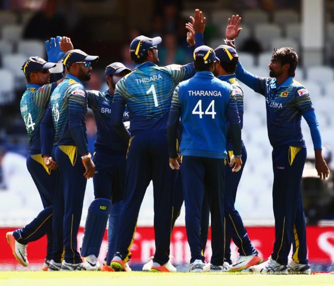 Sri Lanka's players celebrate a wicket during the Champions Trophy match against South Africa