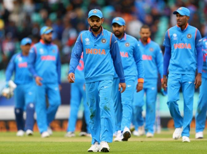 Captain Virat Kohli leads his team off the field