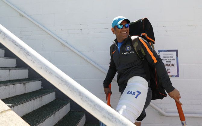 Former India captain Mahendra Singh Dhoni walks out for the training session