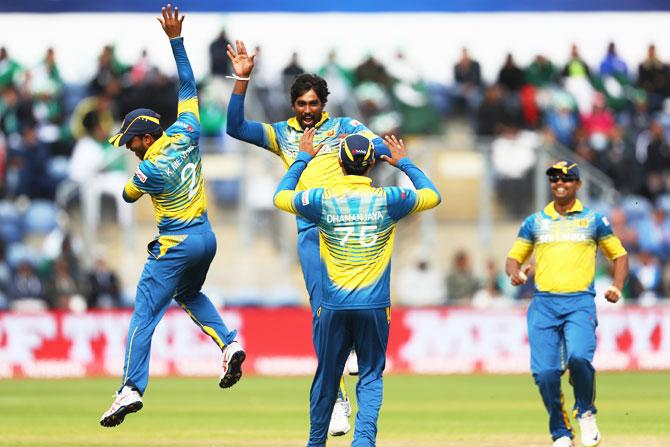 Sri Lanka's Nuwan Pradeep (2nd from left) celebrates with Kusal Mendis (left) after capturing the wicket of Pakistan's Imad Wasim