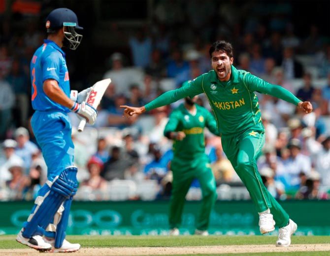 Pakistan's Mohammad Amir celebrates after claiming the wicket of India captain Virat Kohli