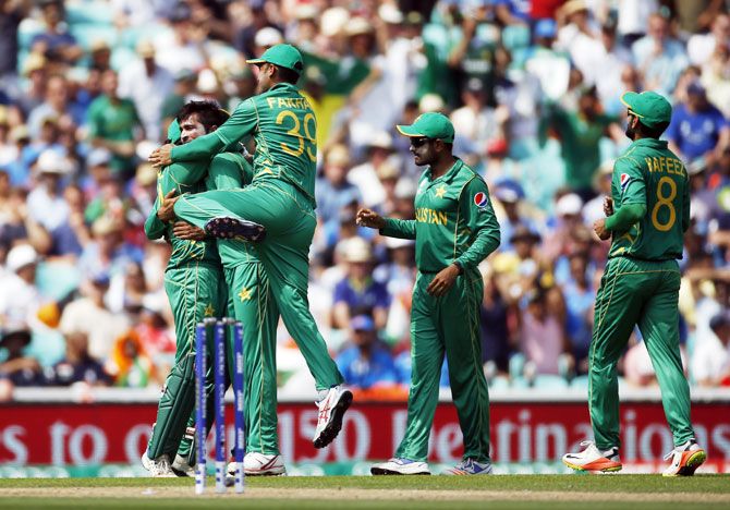 Pakistan’s Mohammad Amir celebrates with team mates after dismissing India’s Shikhar Dhawan