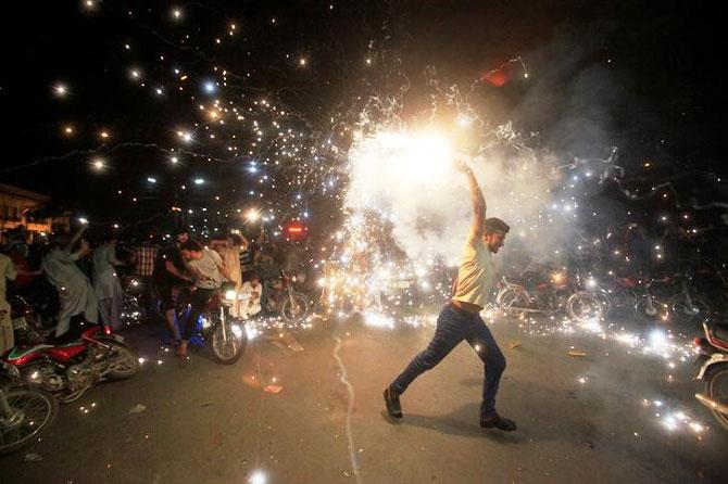 Pakistan fans, in Lahore, celebrate the team's win over India in the Champions Trophy final on Sunday