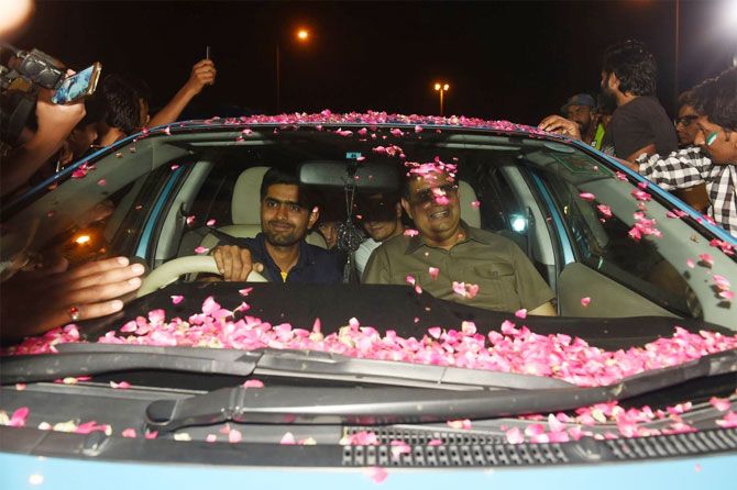 Pakistan officials get a rousing welcome on their arrival in Karachi on Tuesday