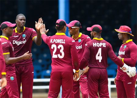 West Indies players celebrate a wicket