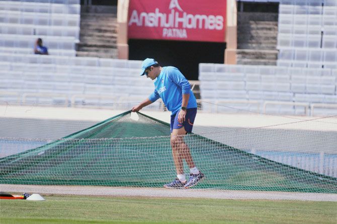  Indian team coach Anil Kumble inspects the pitch during a team training session at the JSCA stadium in Jharkhand