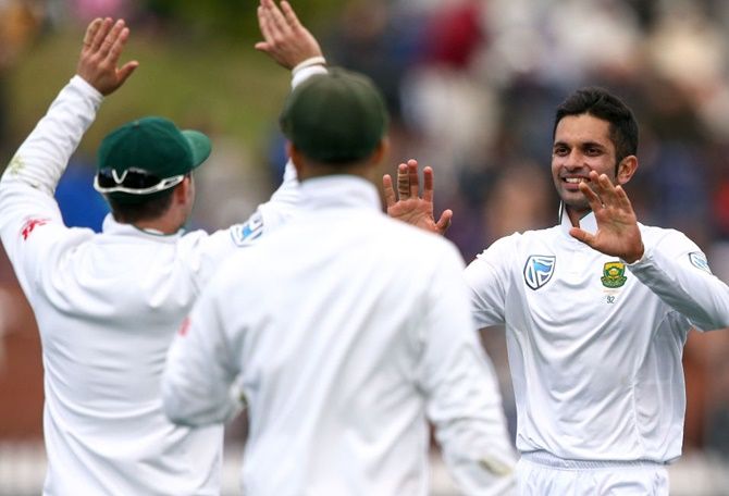 South Africa’s Keshav Maharaj, right, celebrates after taking the wicket of Jeetan Patel of New Zealand at Basin Reserve in Wellington
