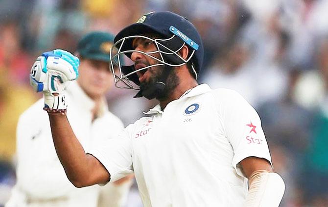 India's Cheteshwar Pujara celebrates on completing his double century