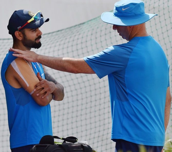 Virat Kohli with team physiotherapist Patrick Farhart during a practice session at HPCA Stadium in Dharamsala on Thursday