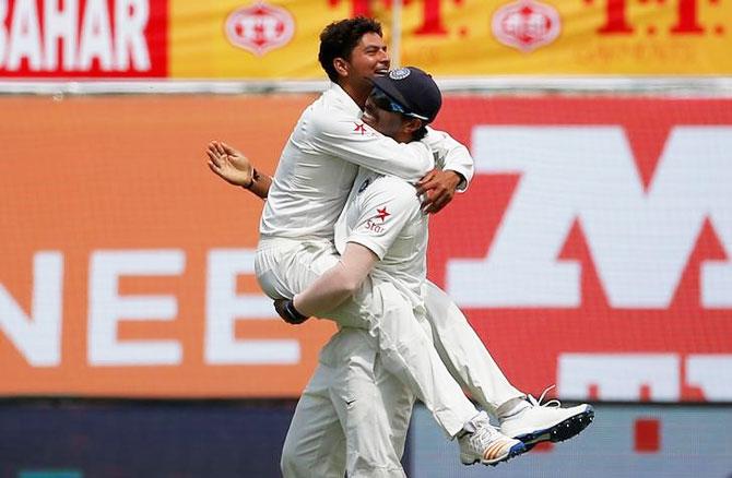 India's Kuldeep Yadav (left) and Umesh Yadav celebrate the dismissal of Australia's Glenn Maxwell on Day 1 of the 4th Test in Dharamsala on Saturday