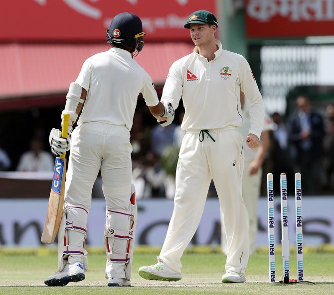 Australia captain Steve Smith, right, congratulates India skipper Ajinkya Rahane after the match on Tuesday