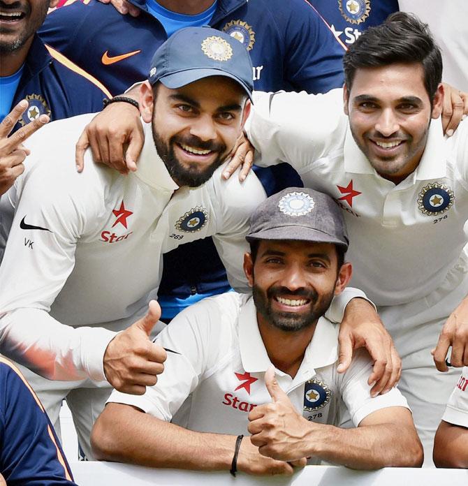 Virat Kohli, Ajinkya Rahane and Bhuvneshwar Kumar celebrate after India's victory in Dharamsala on Tuesday