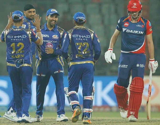 Harbhajan Singh of the Mumbai Indians celebrates with team-mates the wicket of Pat Cummins of the Delhi Daredevils