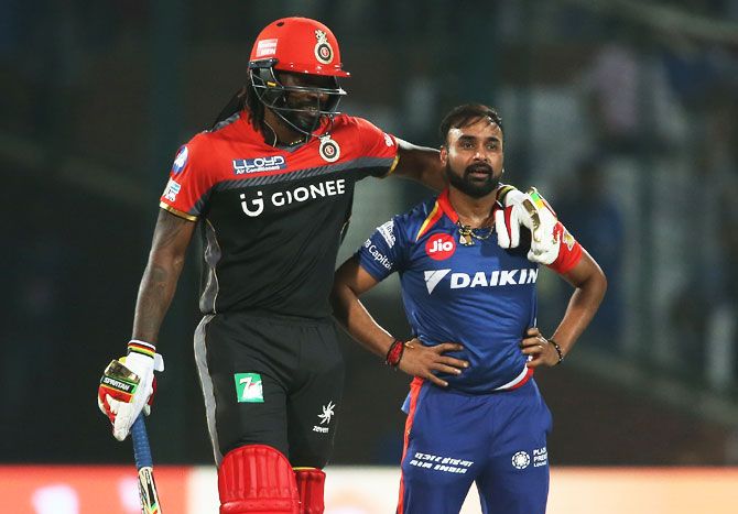 Chris Gayle pus his arms around Amit Mishra as he comforts him after his appeal was turned down by the umpire
