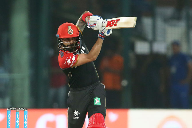 Virat Kohli plays a shot straight down the ground during his innings of 58 against Delhi Daredevils in New Delhi on Sunday