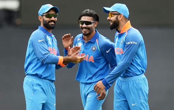 Ravindra Jadeja celebrates with Dinesh Karthik and captain Virat Kohli after claiming a wicket