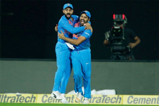 India captain Virat Kohli celebrates with his deputy Rohit Sharma after the fall of a New Zealand wicket during the 3rd T20I in Thiruvananthapuram on Tuesday