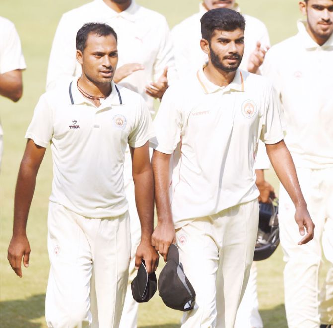 Baroda bowlers Lukman Meriwala (left) and Atit Seth return to the pavilion after taking 5 wickets each during the Ranji trophy match against Mumbai, in Mumbai on Thursday