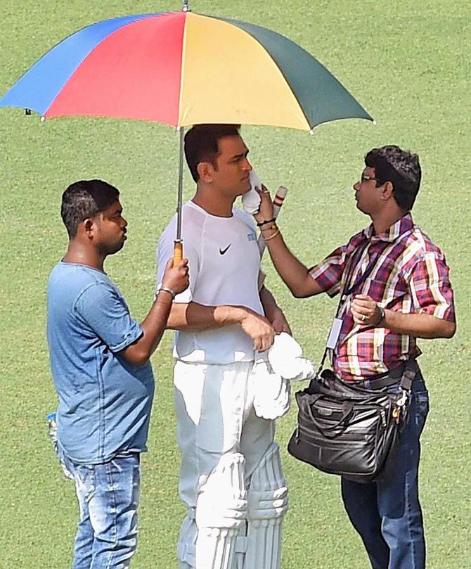 Mahendra Singh Dhoni has make up put on his face in between shots