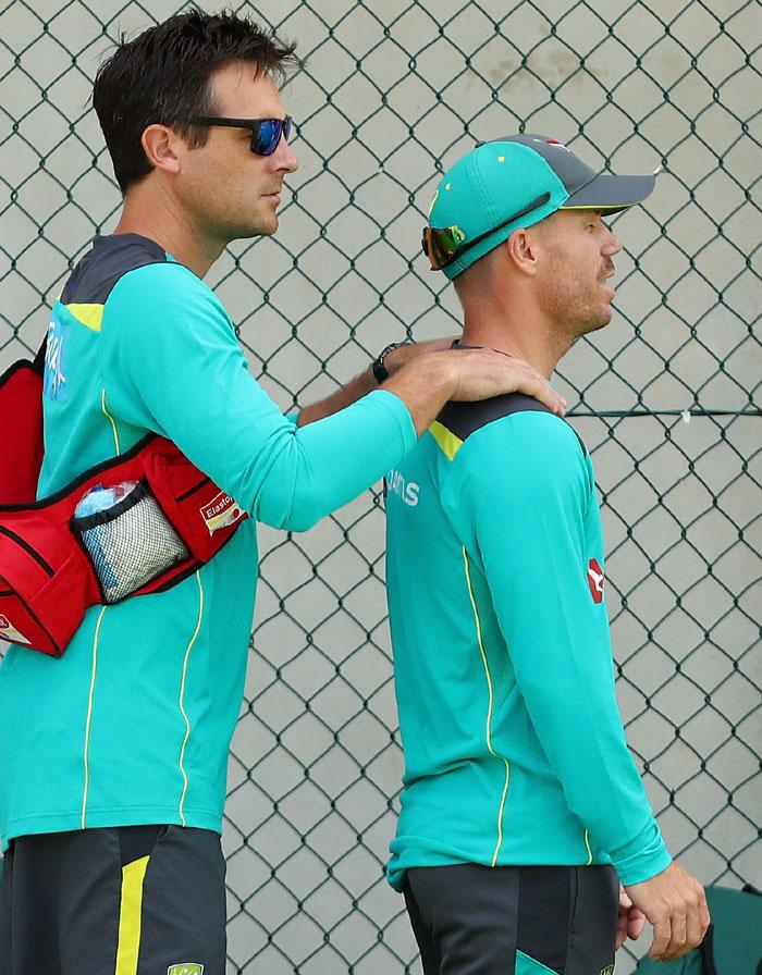 David Warner has his neck massaged during the Australian nets session at The Gabba in Brisbane, Australia, on Tuesday