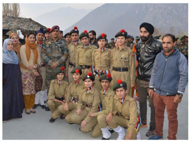 Mahendra Singh Dhoni with budding cricketers from Uri