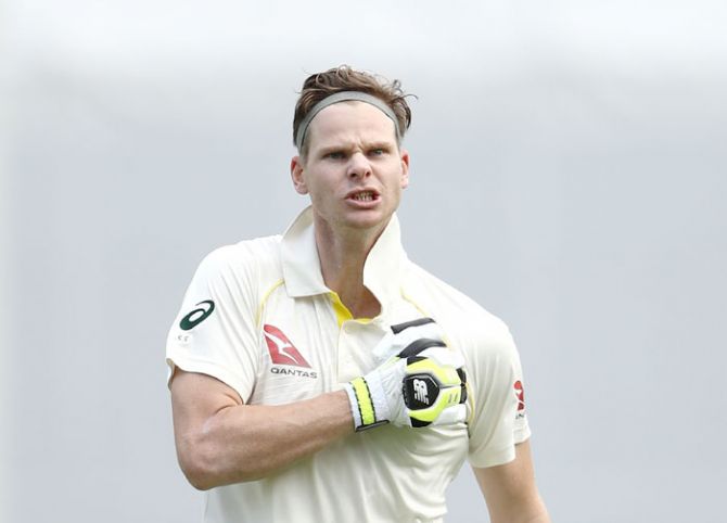 Steve Smith thumps his chest after completing his century against England in the opening Ashes Test at the Gabba in Brisbane on Saturday