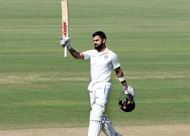 Virat Kohli celebrates after completing his century against Sti Lanka in December 2017