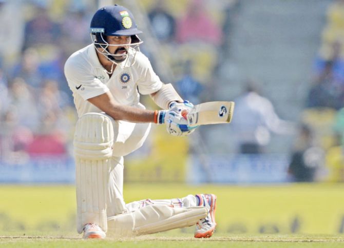 Indian batsman Cheteshwar Pujara plays a sweep shot