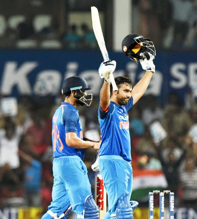 India's Rohit Sharma celebrates after completing his 14th ODI century at the Vidarbha Cricket Association Stadium, in Nagpur, on Sunday