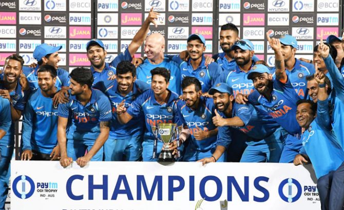 The triumphant Indian cricket team celebrates with the trophy after crushing Australia to record a 4-1 series win on Sunday