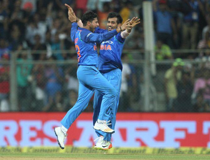 Kuldeep Yadav and Yuzvendra Chahal celebrate New Zealand skipper Kane Williamson's dismissal in the first ODI, in Mumbai, October 23, 2017. Photograph: BCCI