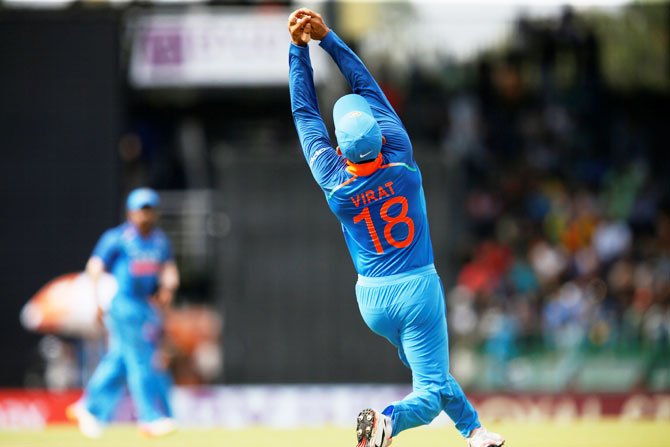 India's captain Virat Kohli takes a catch to dismiss Sri Lanka's Dilshan Munaweera