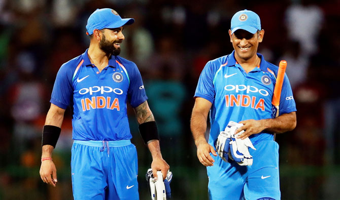 India's captain Virat Kohli and his teammate MS Dhoni celebrate after winning the match and the series against Sri Lanka