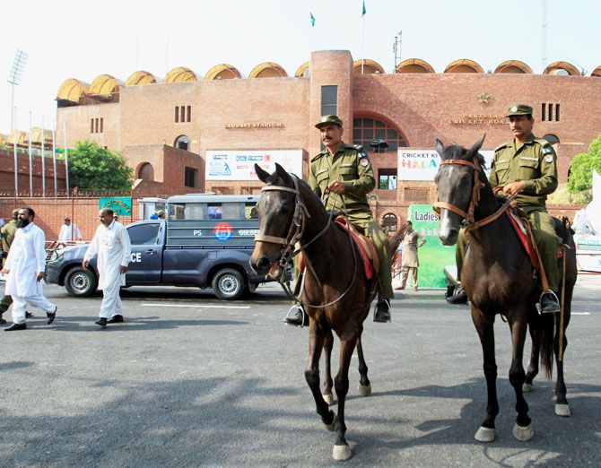 Mounted police officers patrol in front of Gaddafi Cricket Stadium ahead of the World XI cricket series in Lahore