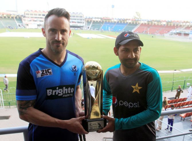 Pakistan captain Sarfraz Ahmed and International World XI captain Faf du Plessis hold the Independence Cup trophy at the Gaddafi Cricket Stadium in Lahore, on Monday