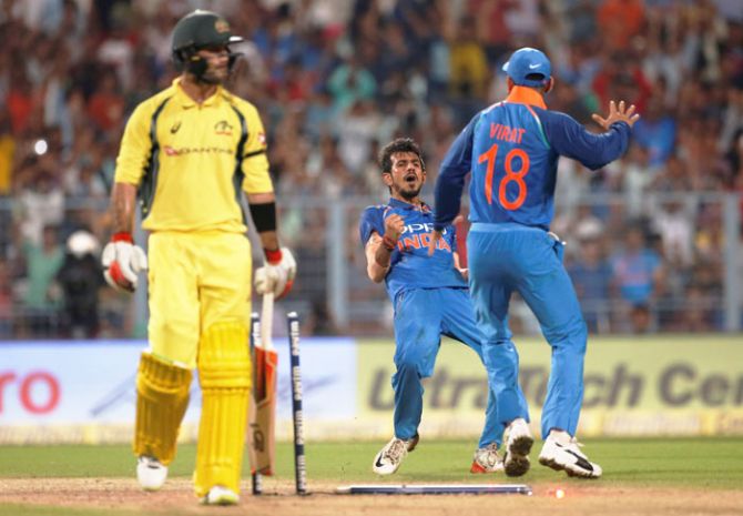 India's Yuzvendra Chahal (centre) celebrates with captain Virat Kohli (right) after dismissing Australia's Glenn Maxwell during the 2nd ODI at Eden Gardens in Kolkata on Thursday