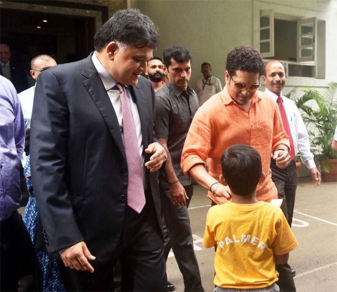 Sachin Tendulkar obliges a young fan with an autograph at the CCI on Friday