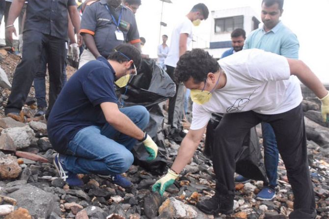 Sachin Tendulkar gives Aaditya Thackeray a hand as they clean up par of Bandra Fort in Mumbai, and marking the start of Swachh Bharat Week on Monday