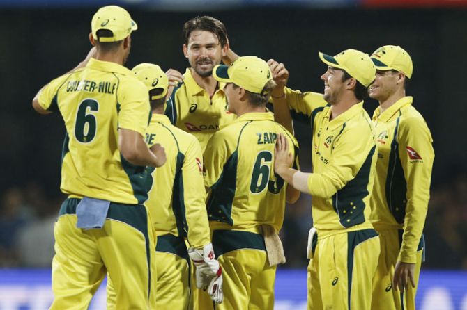 Australia's Kane Richardson celebrates with teammates after dismissing India's Mahendra Singh Dhoni during the 4th One Day International at the M Chinnaswamy Stadium in Bengaluru on Thursday