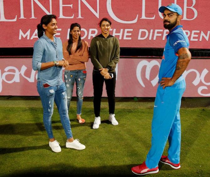 Harmanpreet Kaur (left), and Smriti Mandana (2nd from right) speak with Virat Kohli