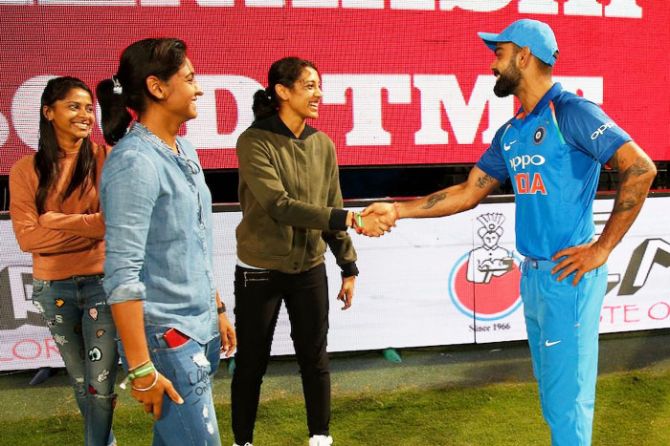 India women cricketers Harmanpreet Kaur and Smriti Mandana meet Virat Kohli after a match in Bengaluru on September 28, 2017